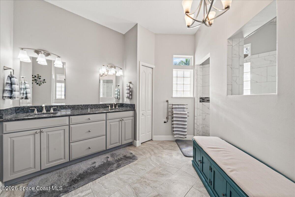 1050 Starling Way Rockledge, FL 32955 - Photo 21 of 59 a spacious bathroom with double vanity and a mirror
