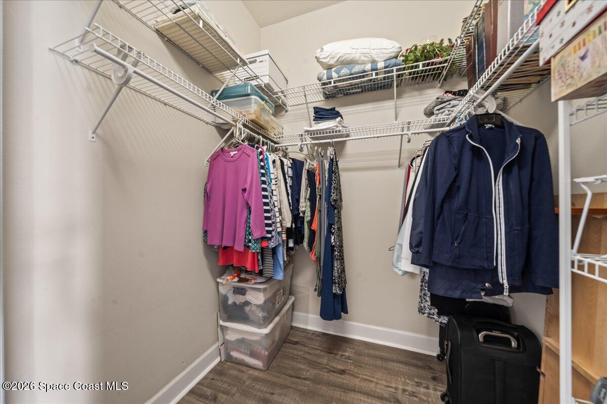 1050 Starling Way Rockledge, FL 32955 - Photo 24 of 59 a view of walk in closet with clothes and shoes