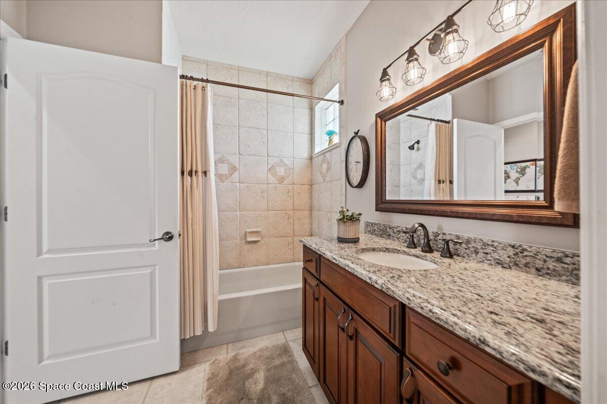 1050 Starling Way Rockledge, FL 32955 - Photo 27 of 59 a bathroom with a granite countertop double vanity sink and a mirror