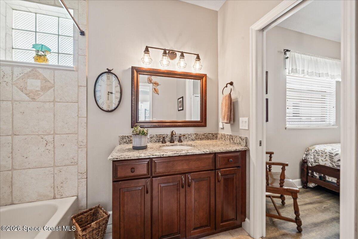 1050 Starling Way Rockledge, FL 32955 - Photo 28 of 59 a bathroom with a sink and a mirror