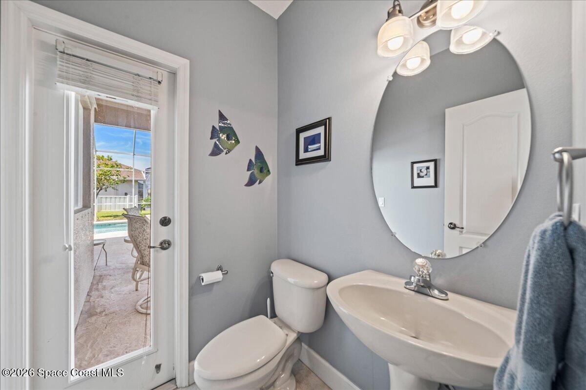 1050 Starling Way Rockledge, FL 32955 - Photo 30 of 59 a bathroom with a sink a toilet and shower