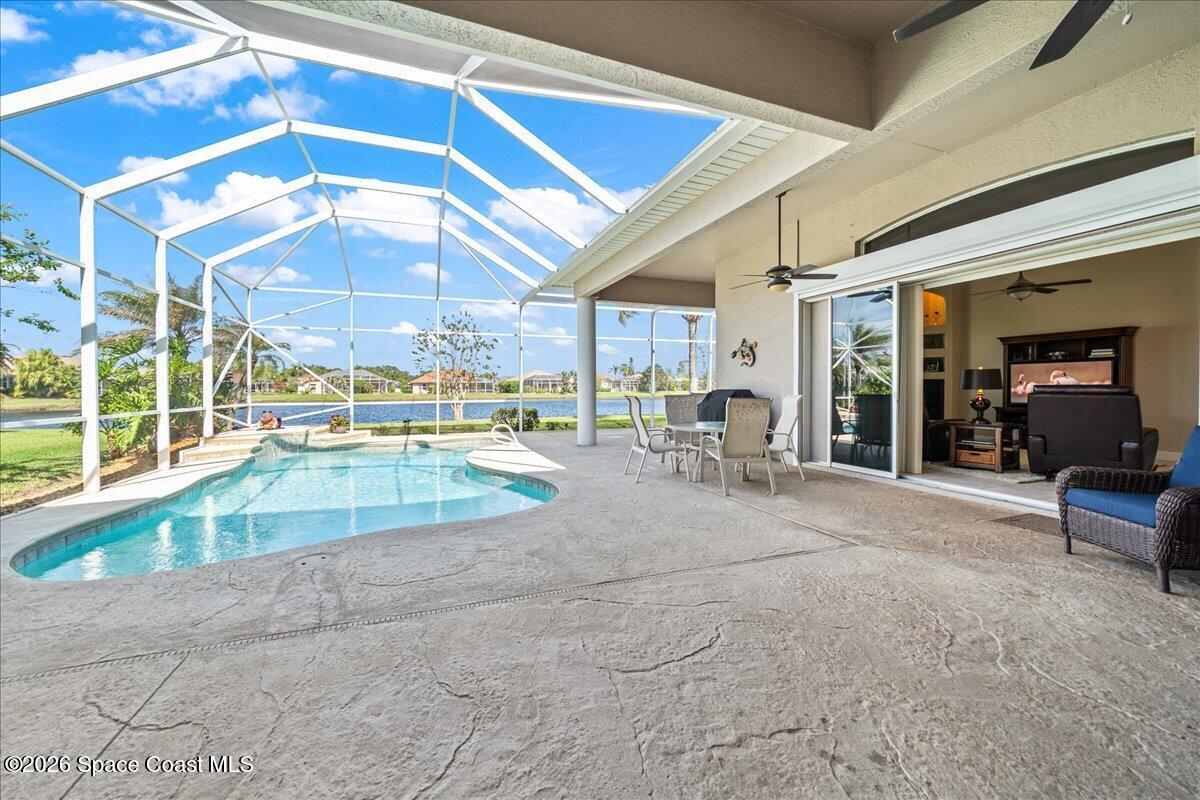 1050 Starling Way Rockledge, FL 32955 - Photo 33 of 59 a view of a patio with a table and chairs under an umbrella