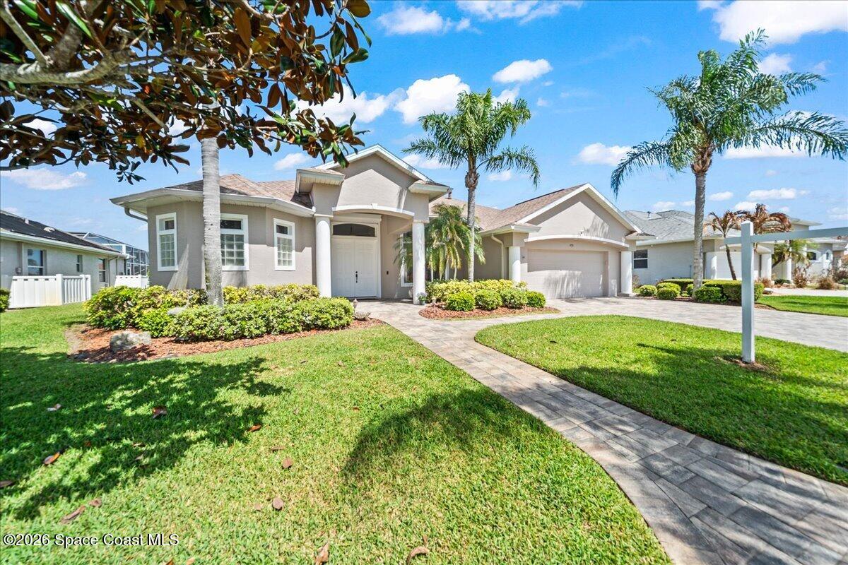 1050 Starling Way Rockledge, FL 32955 - Photo 4 of 59 a front view of a house with a yard