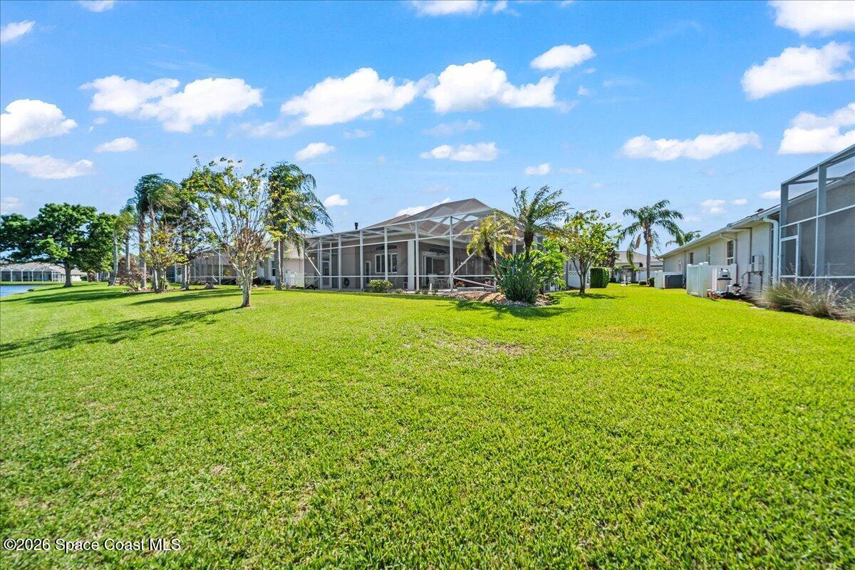 1050 Starling Way Rockledge, FL 32955 - Photo 46 of 59 a view of a house with a big yard and potted plants