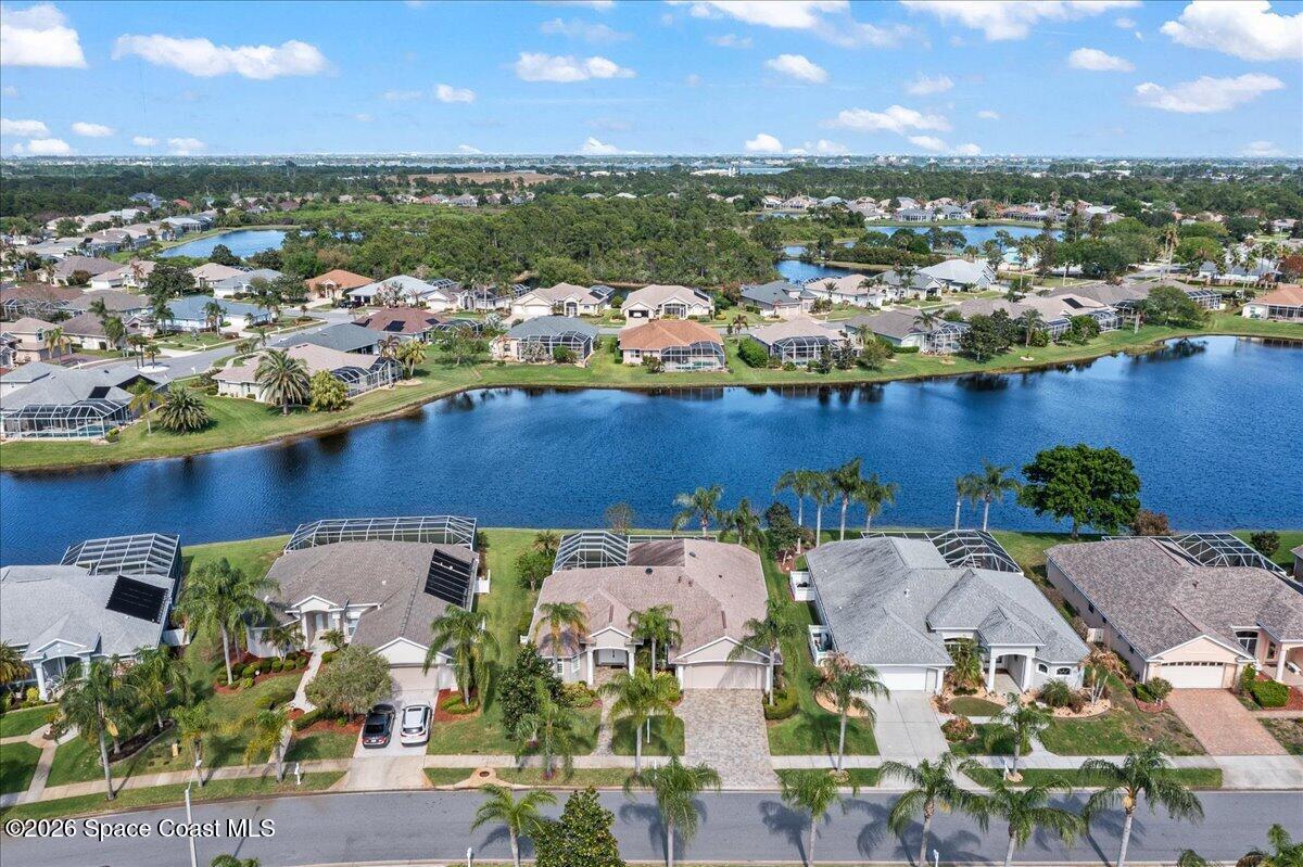 1050 Starling Way Rockledge, FL 32955 - Photo 48 of 59 an aerial view of multiple houses with yard