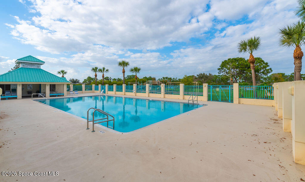 1050 Starling Way Rockledge, FL 32955 - Photo 56 of 59 a view of a swimming pool with a yard