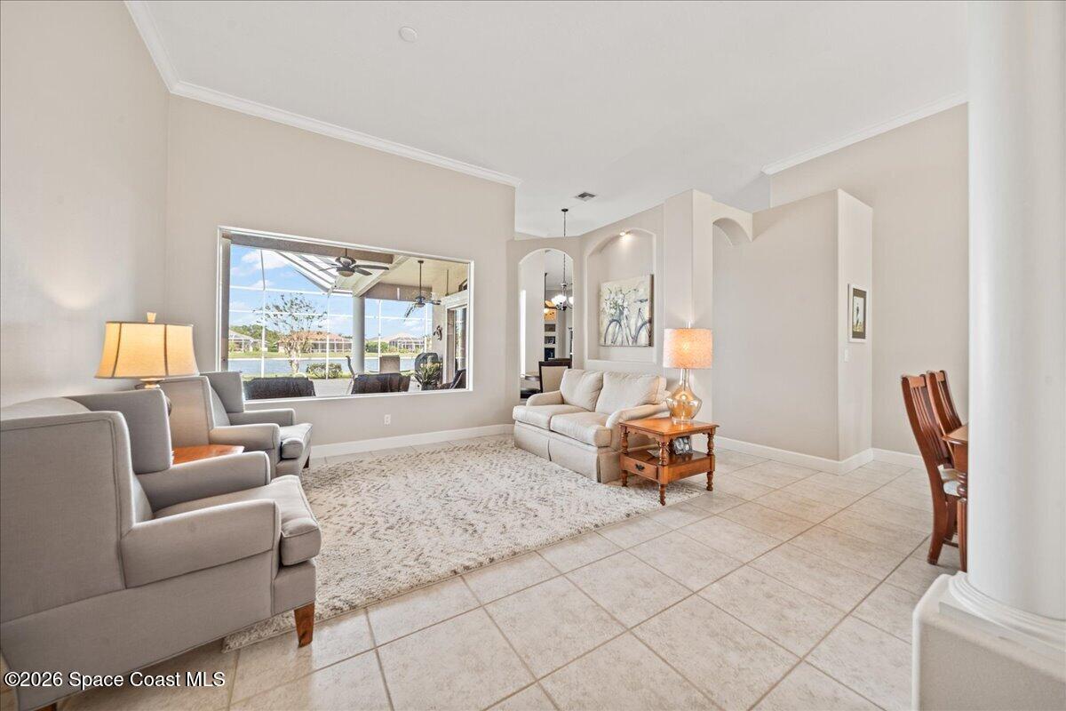 1050 Starling Way Rockledge, FL 32955 - Photo 8 of 59 a living room with furniture and a large window