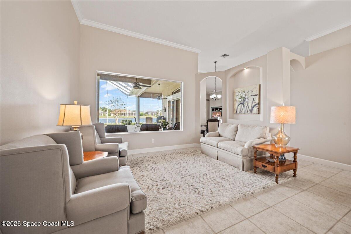 1050 Starling Way Rockledge, FL 32955 - Photo 9 of 59 a living room with furniture and a large window