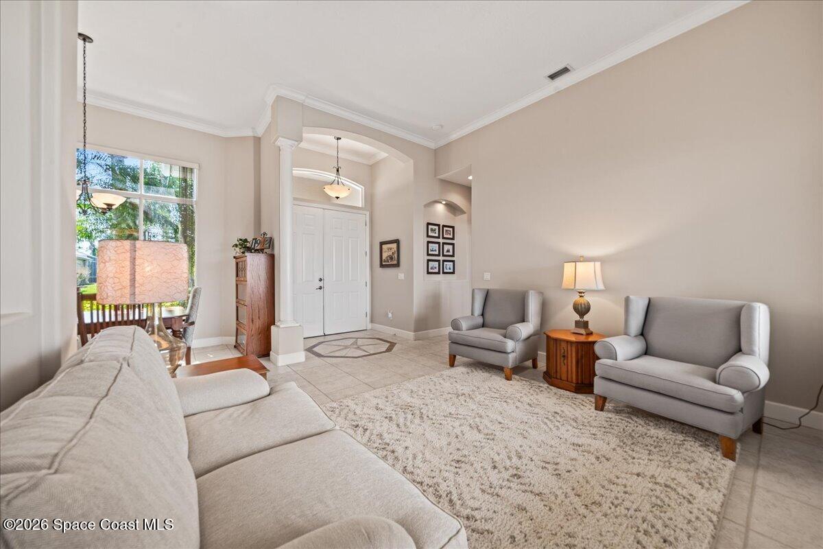 1050 Starling Way Rockledge, FL 32955 - Photo 10 of 59 a living room with furniture and a large window