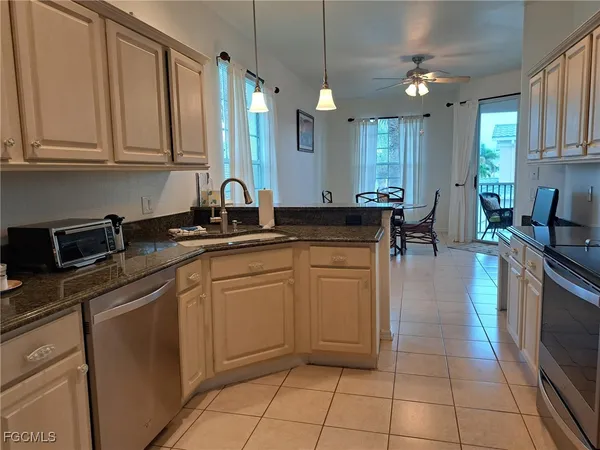 a kitchen with stainless steel appliances granite countertop a sink counter space cabinets and a sink