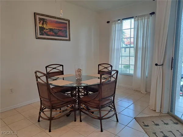 a view of a dining room with furniture and window