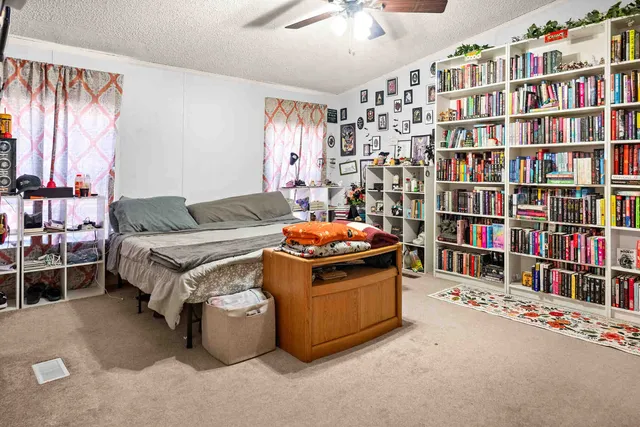 a living room with furniture cabinets and a book shelf