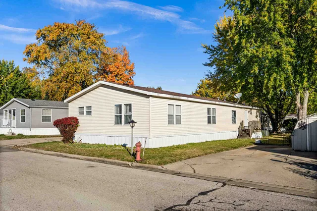 a view of a white house with a yard