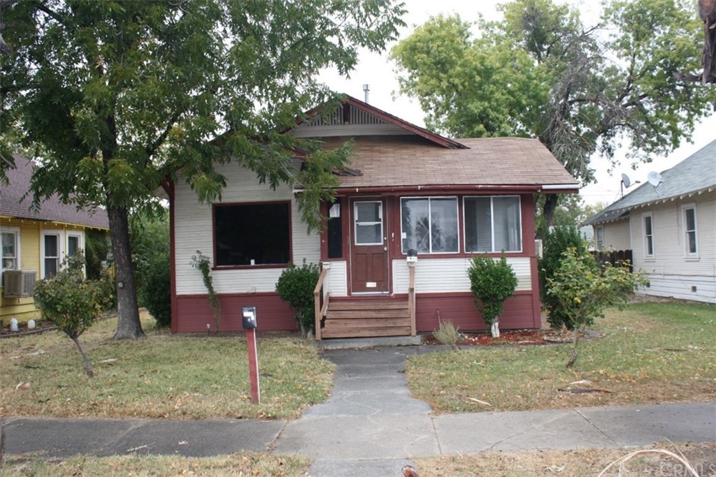 a front view of a house with a yard table and chairs