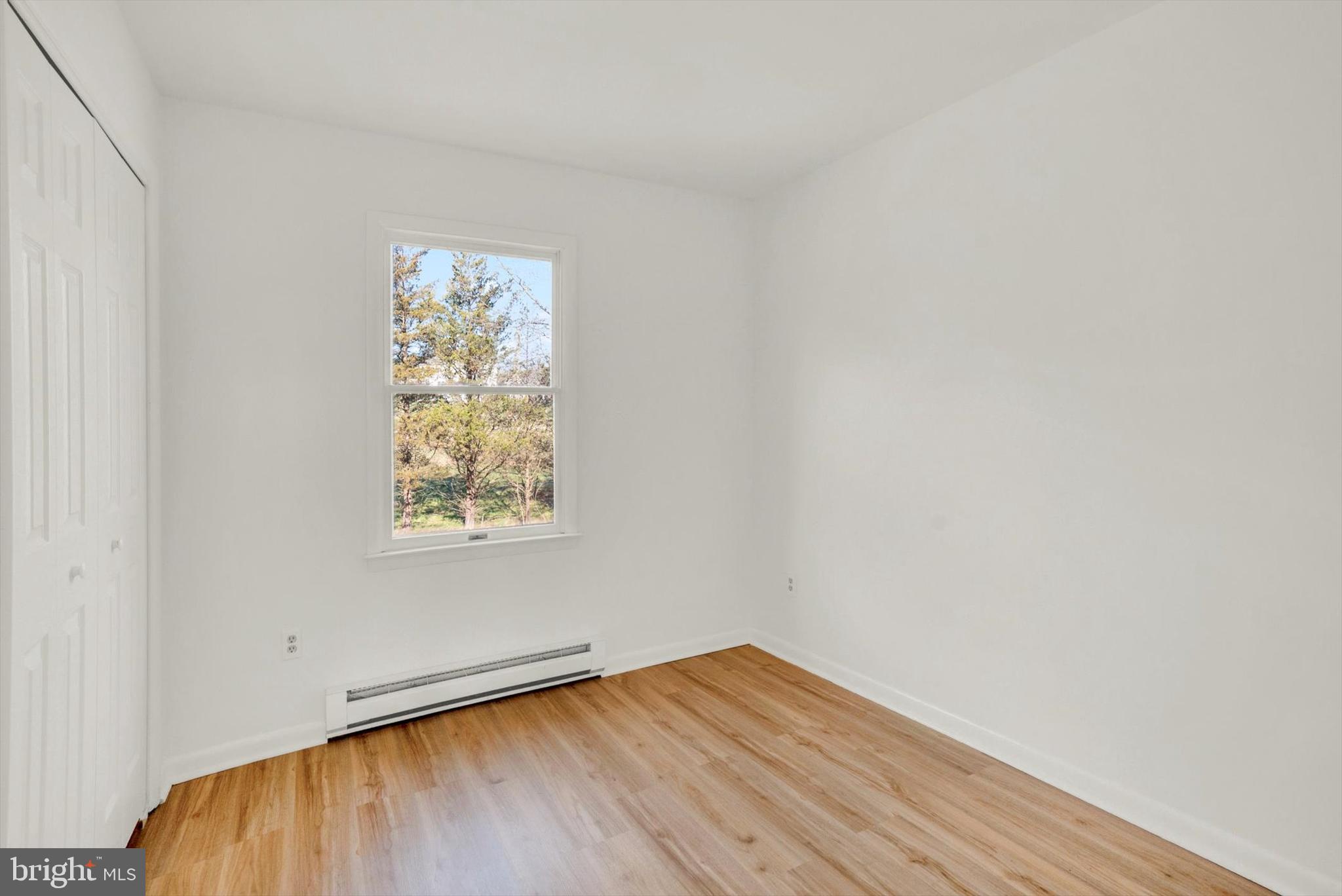 5400 Curley Hill Road Doylestown, PA 18902 - Photo 11 of 47 an empty room with wooden floor and windows