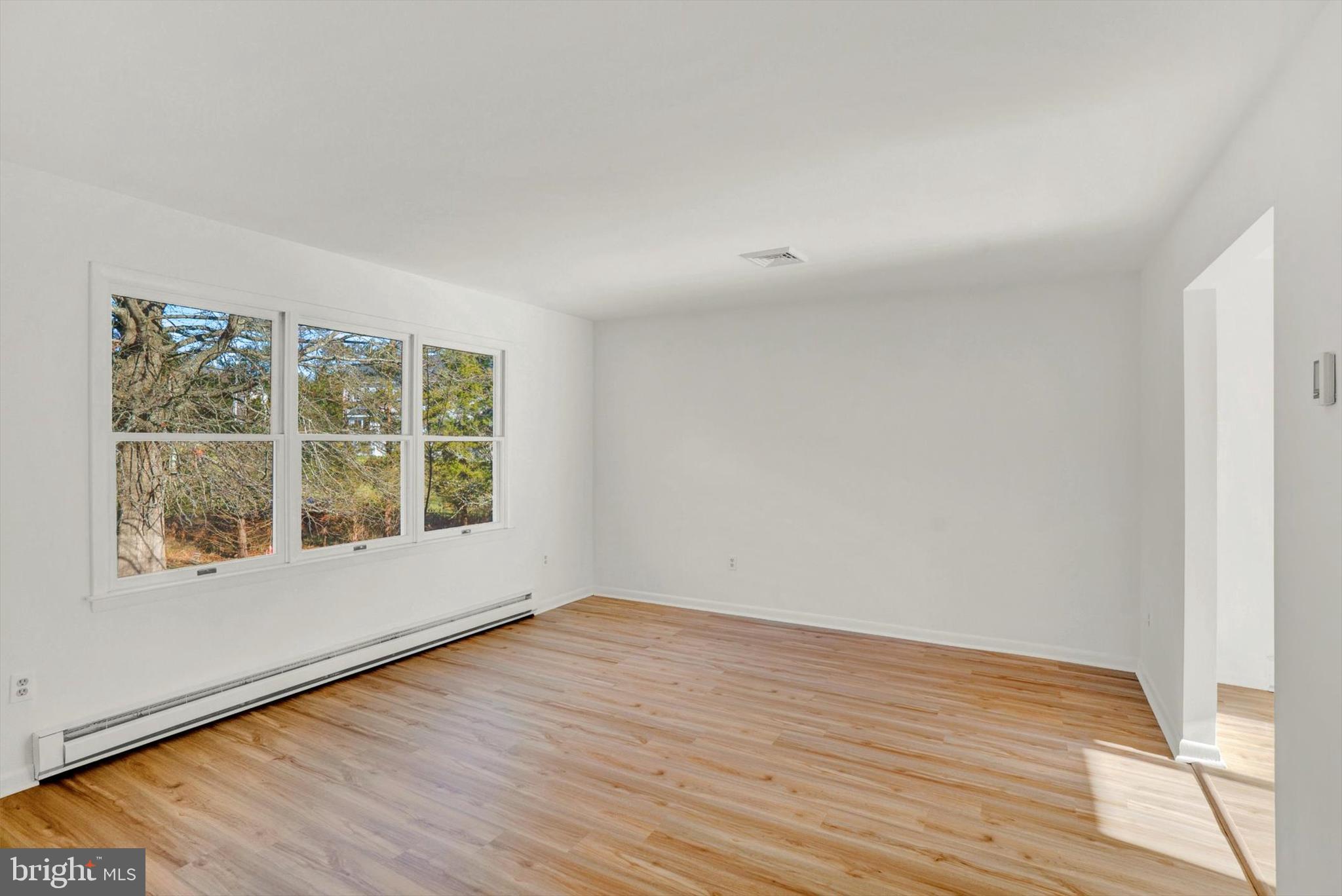 5400 Curley Hill Road Doylestown, PA 18902 - Photo 2 of 47 wooden floor in an empty room with a window