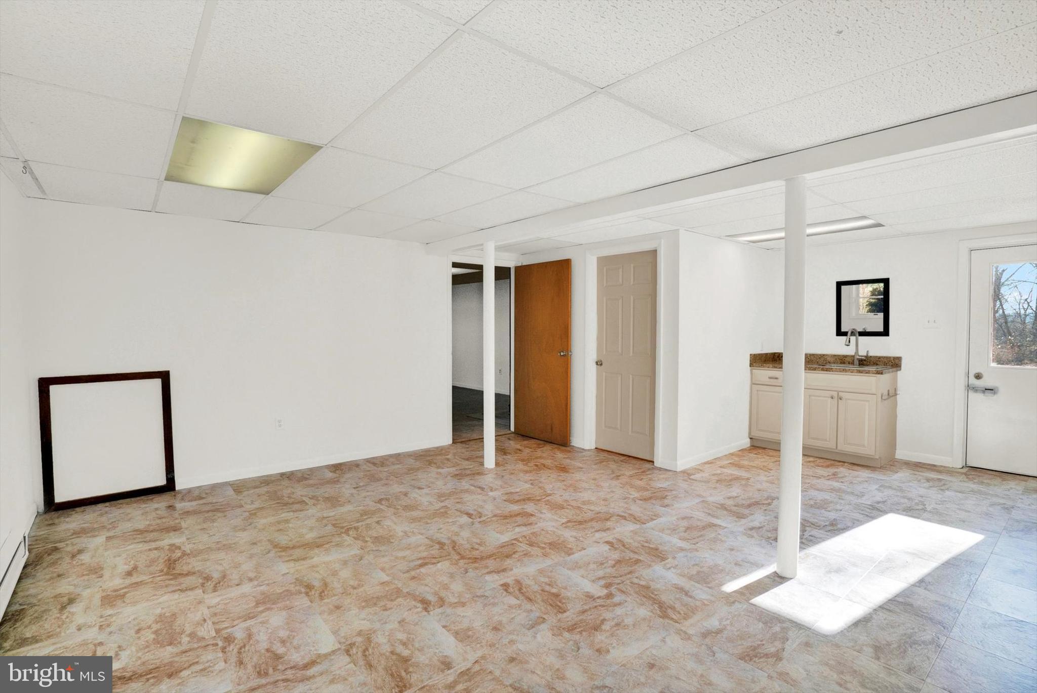 5400 Curley Hill Road Doylestown, PA 18902 - Photo 22 of 47 a view of a livingroom with wooden floor and kitchen space