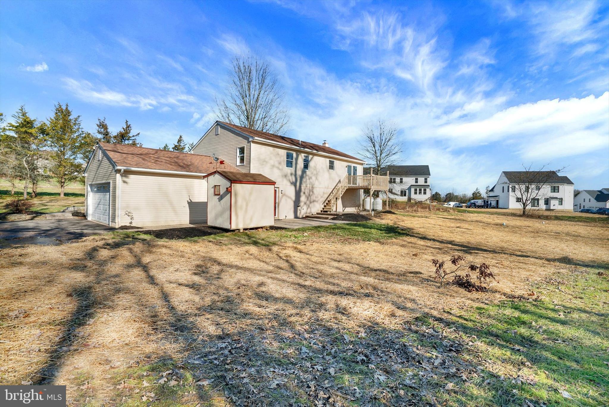5400 Curley Hill Road Doylestown, PA 18902 - Photo 27 of 47 a view of a white house with a big yard and large trees