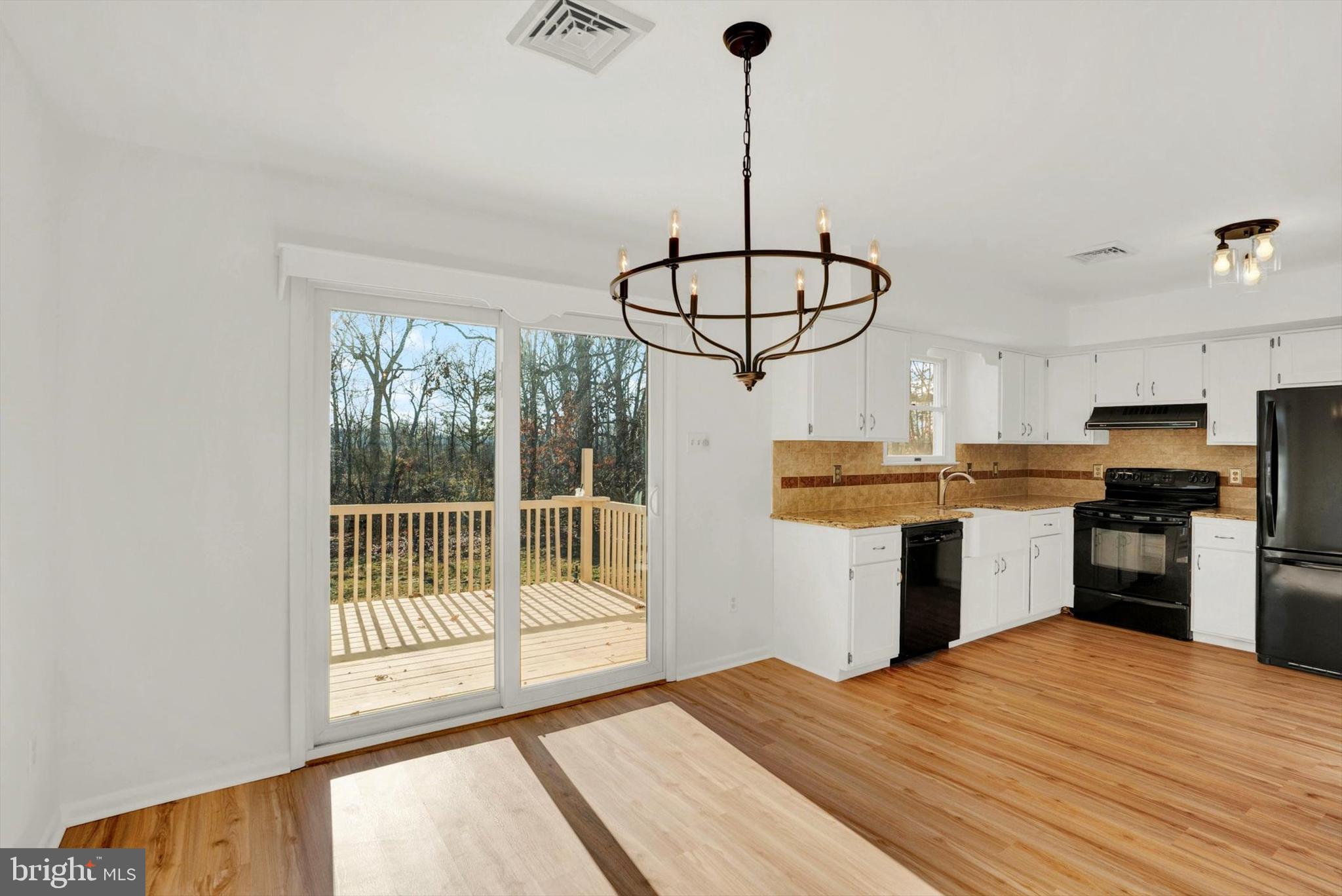 5400 Curley Hill Road Doylestown, PA 18902 - Photo 3 of 47 a kitchen with stainless steel appliances kitchen island a stove a refrigerator a sink and a fireplace