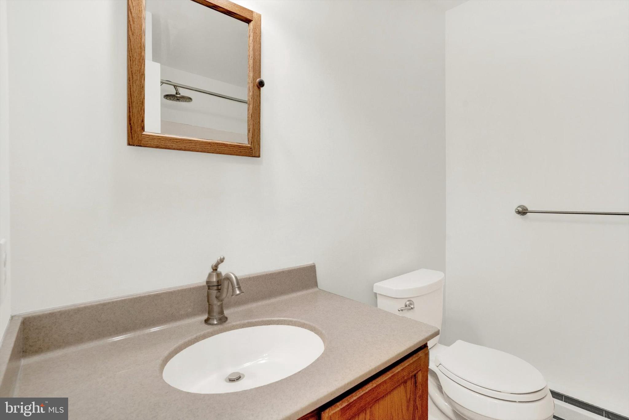 5400 Curley Hill Road Doylestown, PA 18902 - Photo 10 of 47 a bathroom with a sink a toilet and mirror