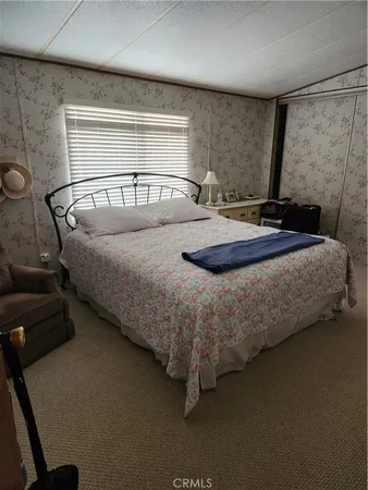 a bedroom with a bed and a mirror