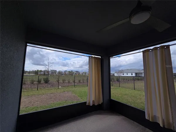 a view of room with large windows and city view