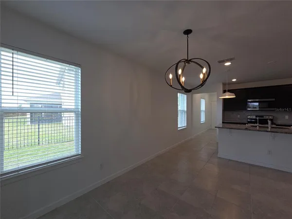 a view of room with a ceiling fan and window