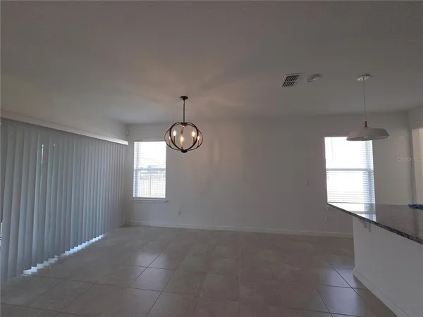 a view of a refrigerator in kitchen and a glass door