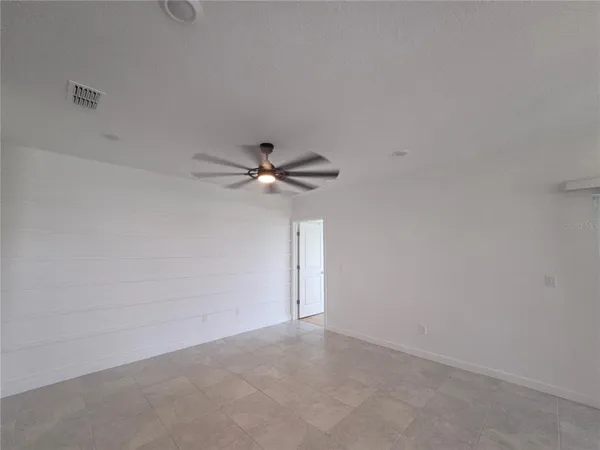 a kitchen with stainless steel appliances granite countertop a refrigerator a sink a stove a microwave a dining table and chairs