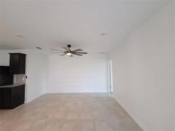 a kitchen with stainless steel appliances granite countertop a sink a stove a microwave and a refrigerator