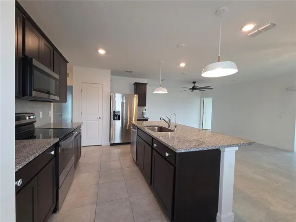 a kitchen with a refrigerator and a sink