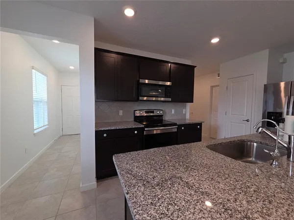 a bathroom with a granite countertop sink a large mirror and a shower