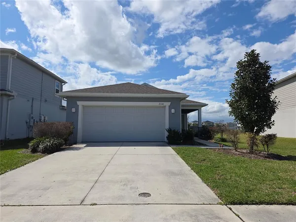 a front view of house with yard and green space