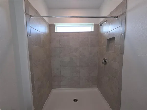 an empty room with wooden floor and window