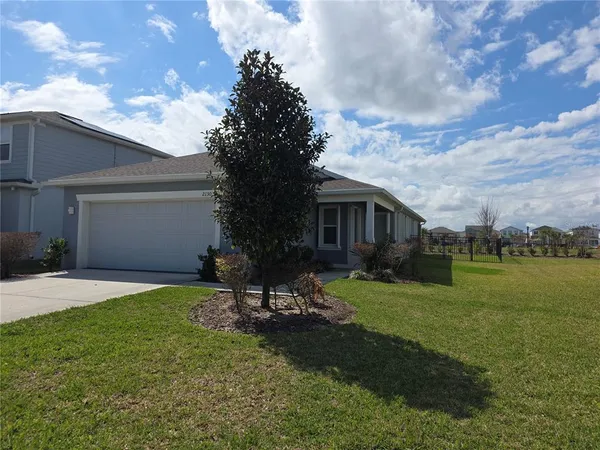 a backyard of a house with table and chairs