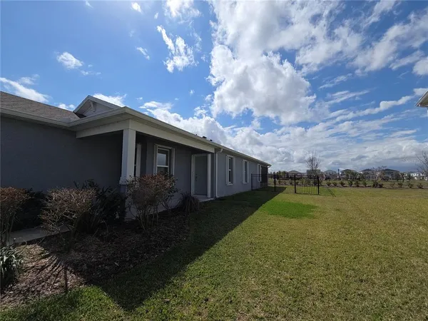 a backyard of a house with lots of green space