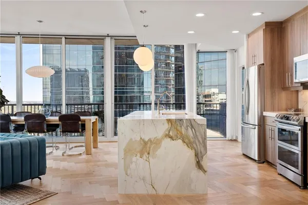 a living room with furniture and a floor to ceiling window