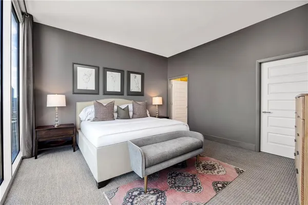 a bedroom with a bed next to a window with outer view