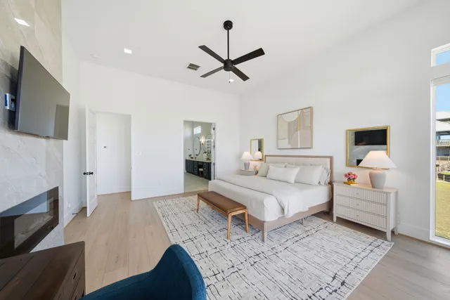 a bedroom with a large bed and a chandelier