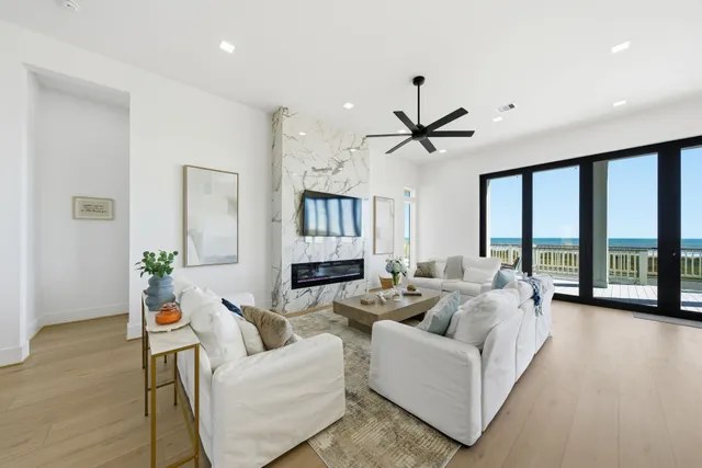 a large kitchen with stainless steel appliances a large counter top a stove a chimney a sink and a refrigerator