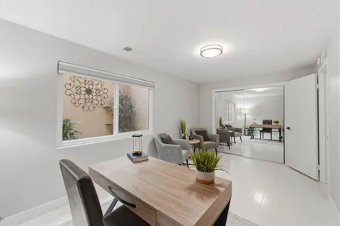 a living room with furniture and large windows