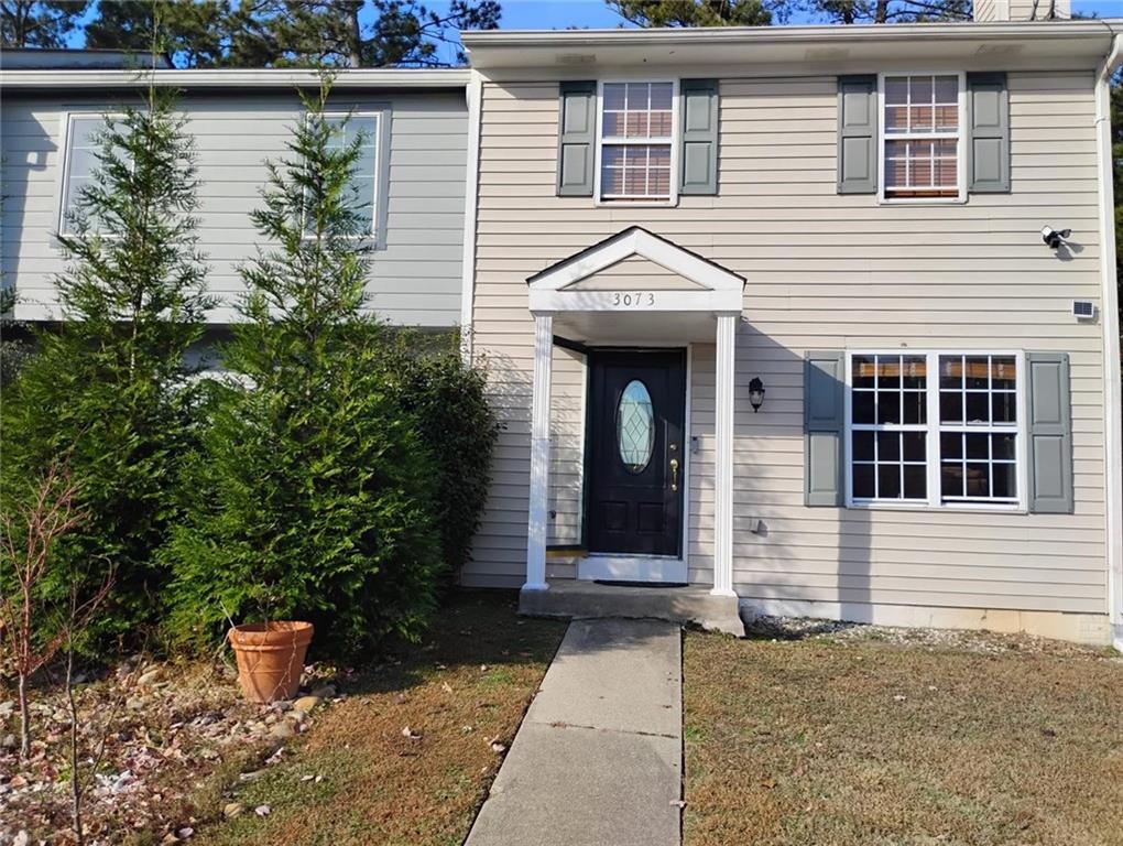 a front view of a house with plants