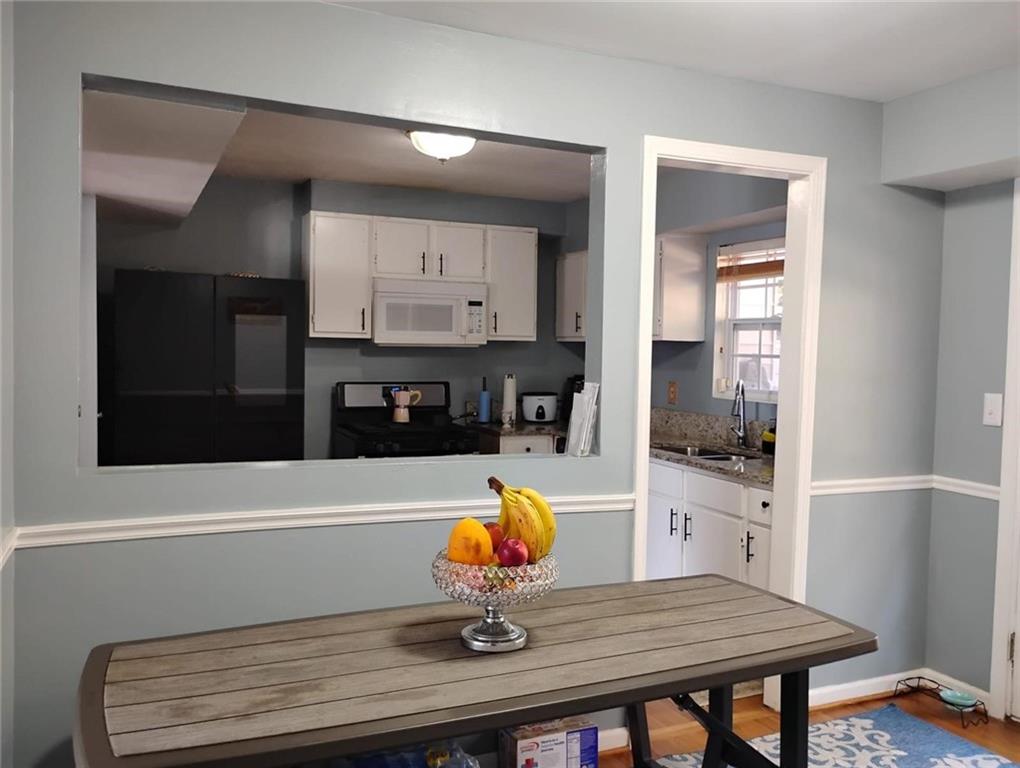 3073 Shadow Walk Lane Tucker, GA 30084 - Photo 3 of 48 a kitchen with stainless steel appliances a kitchen island microwave and cabinets