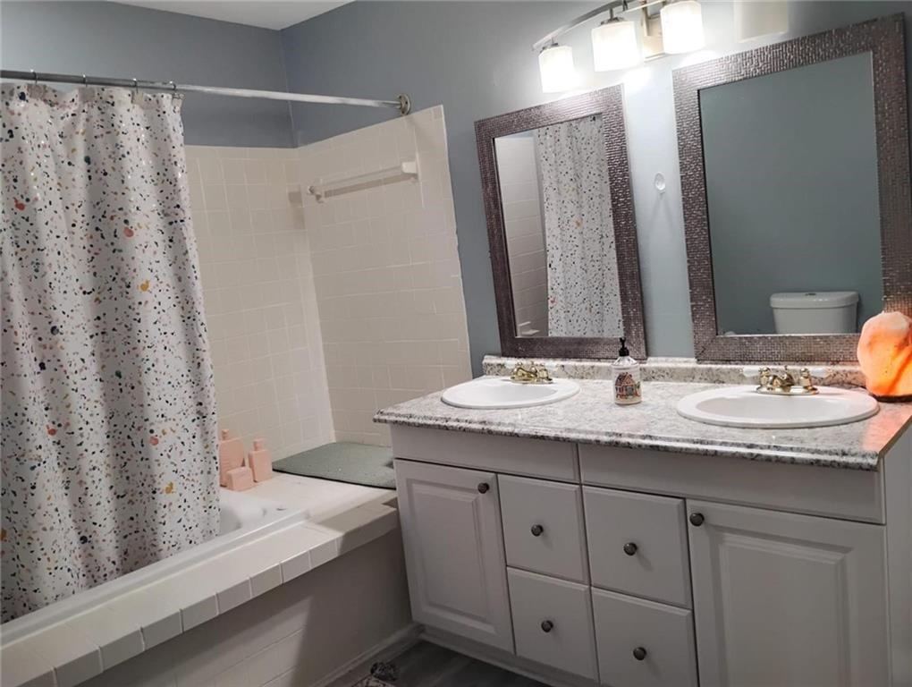 3073 Shadow Walk Lane Tucker, GA 30084 - Photo 33 of 48 a bathroom with a granite countertop sink and a mirror