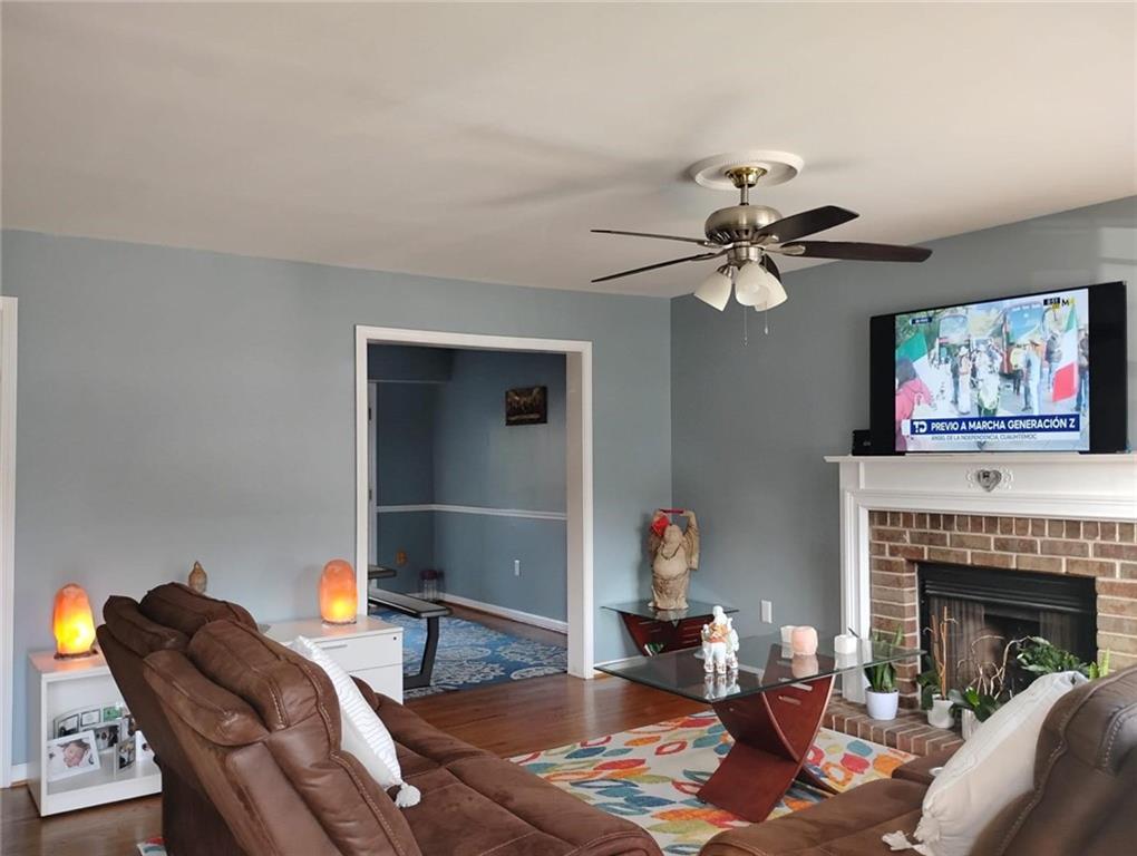3073 Shadow Walk Lane Tucker, GA 30084 - Photo 9 of 48 a living room with furniture a fireplace and a flat screen tv