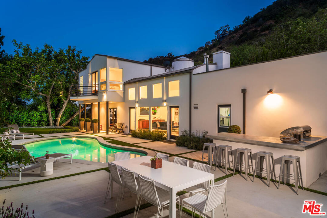 1500 Roscomare Road Los Angeles, CA 90077 - Photo 1 of 1 a backyard of a house with table and chairs