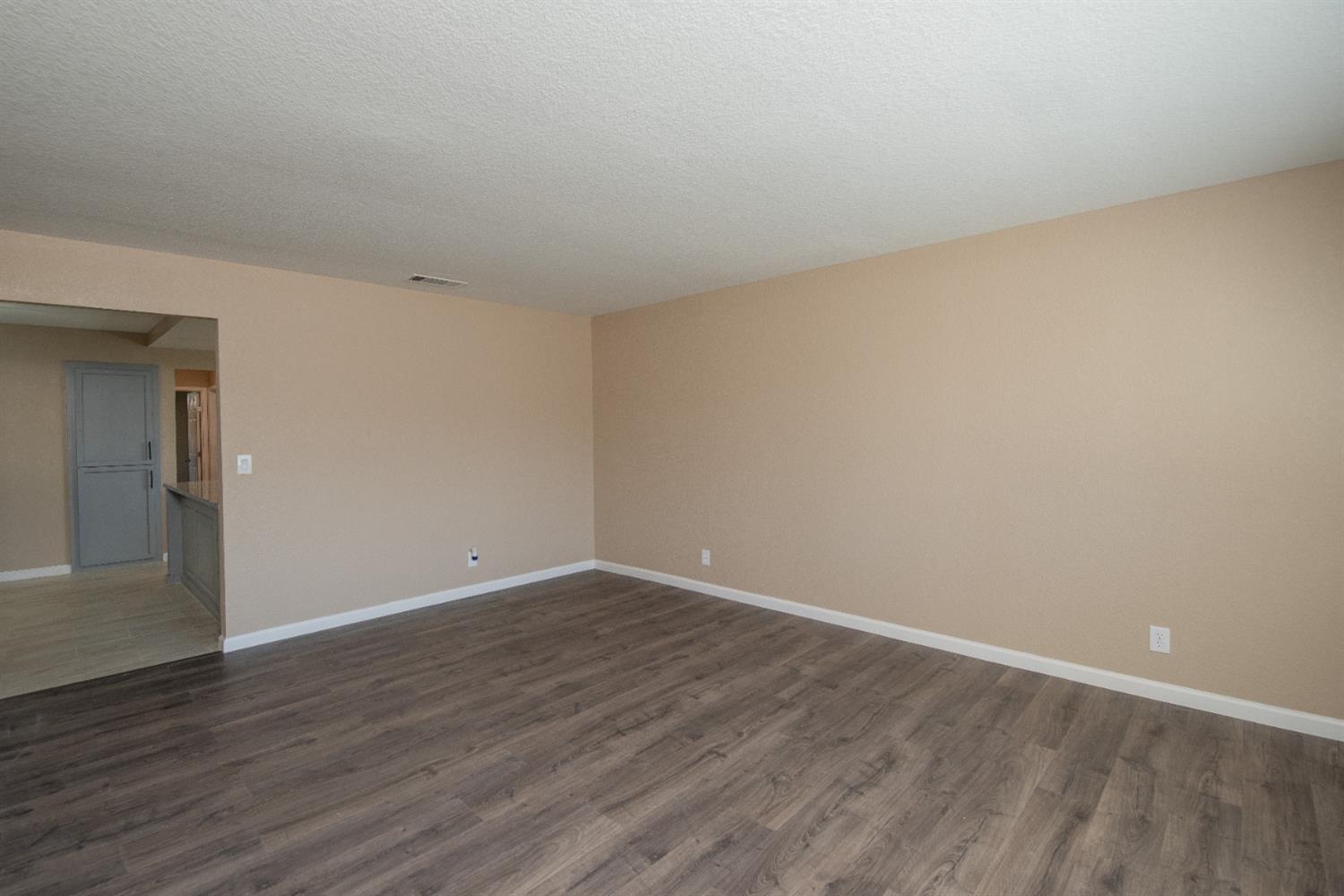 1621 Davis Street Ripon, CA 95366 - Photo 16 of 43 empty room with baseboards and dark wood finished floors
