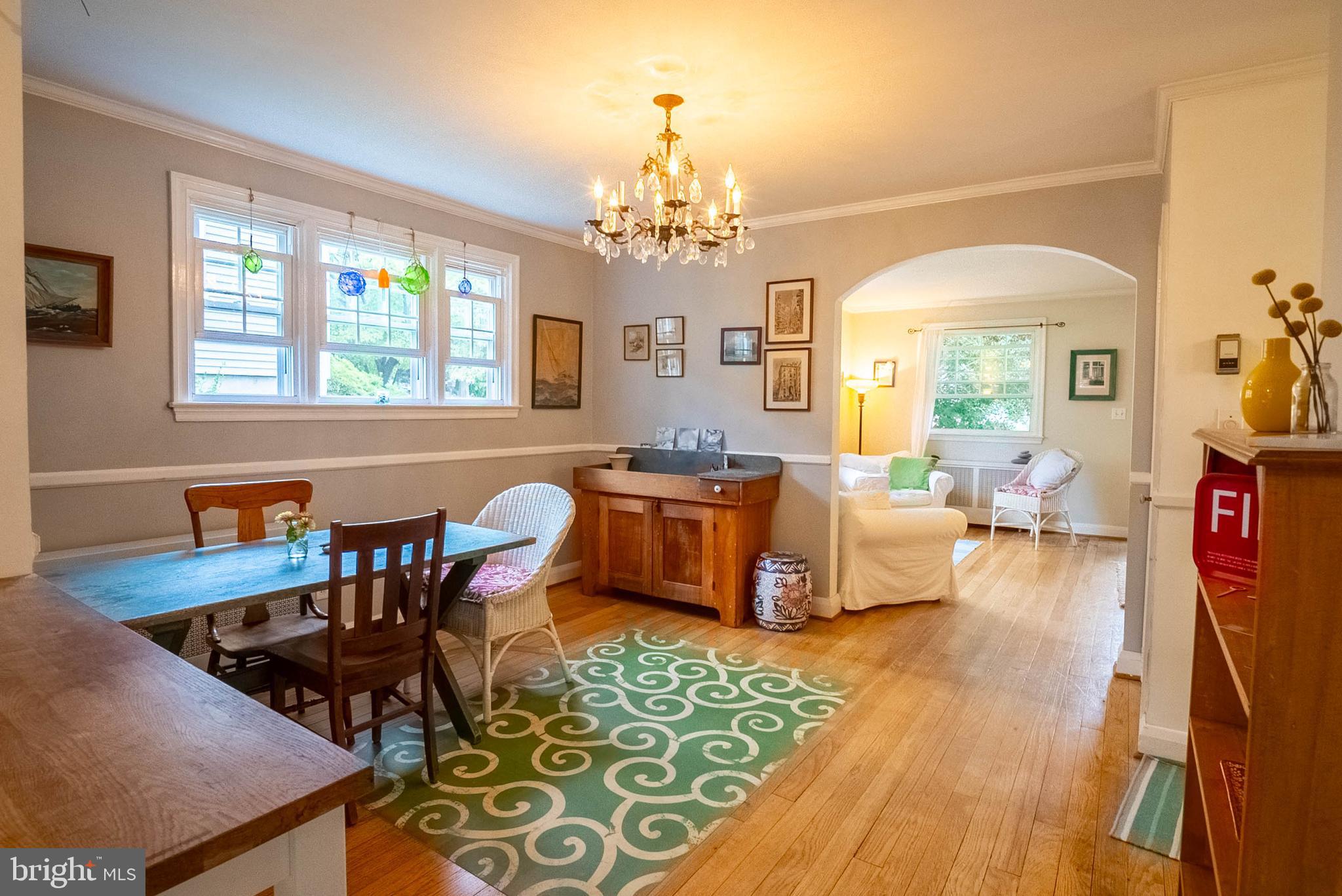 6400 Crestwood Road Baltimore, MD 21239 - Photo 12 of 39 a living room with furniture and a chandelier