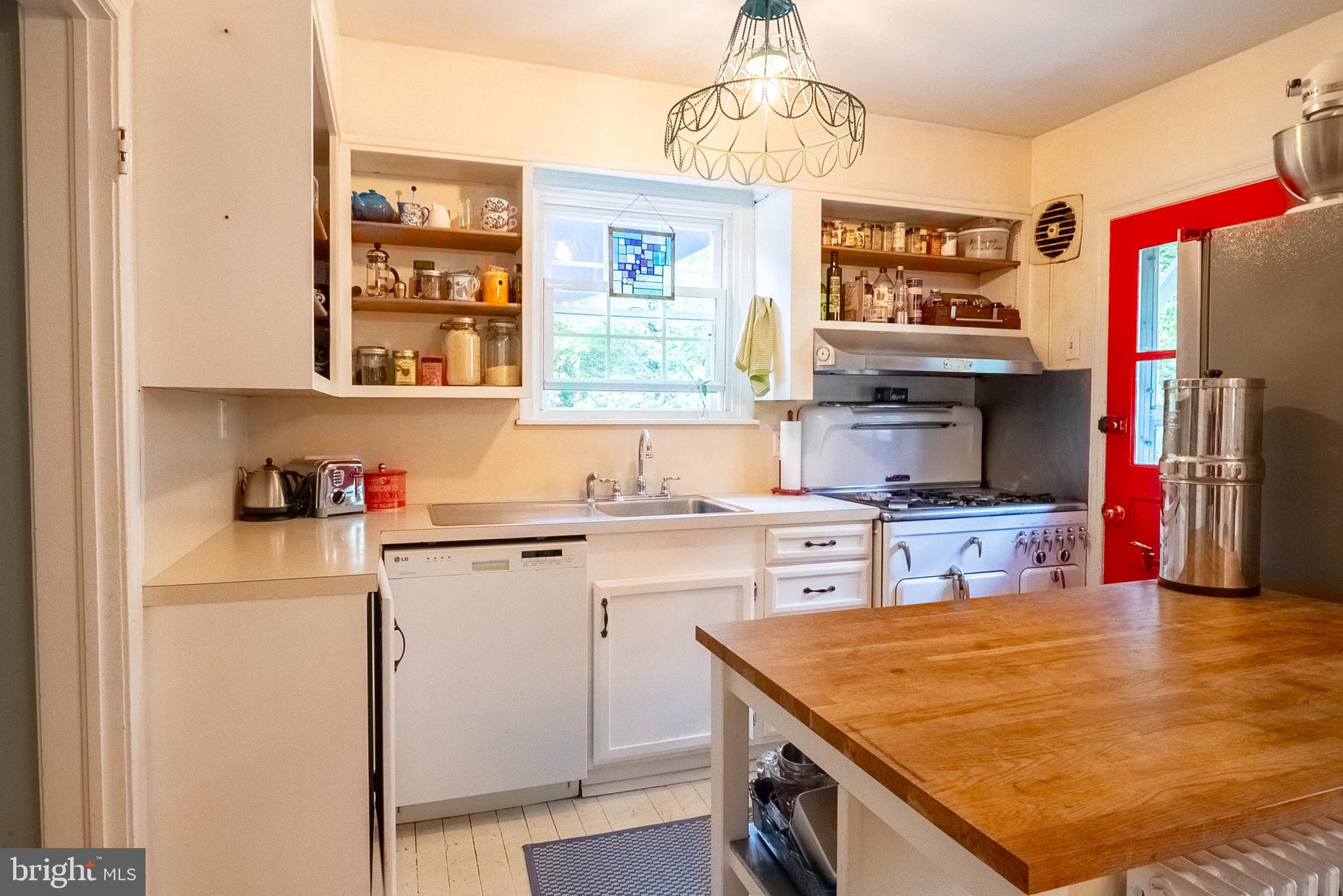 6400 Crestwood Road Baltimore, MD 21239 - Photo 17 of 39 a kitchen with a stove a sink and a refrigerator
