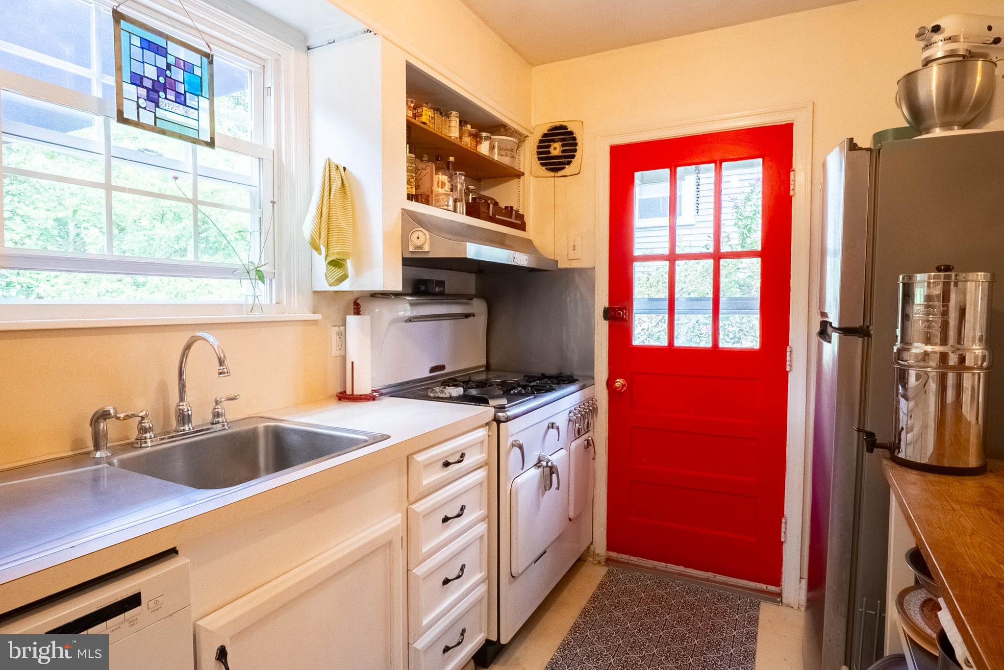 6400 Crestwood Road Baltimore, MD 21239 - Photo 18 of 39 a kitchen that has a sink wooden floor and a stove